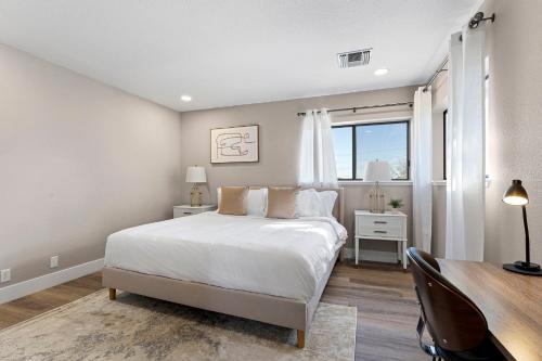a bedroom with a bed and a desk and a window at Elegant 4BD Reno Abode, close to Shops and Casinos in Reno