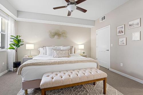 a bedroom with a large bed with a ceiling fan at Designer Apt w Jacuzzi Walk To Casino & iMax in Sparks