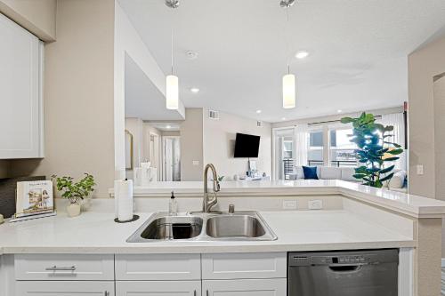 a kitchen with a sink and a large mirror at Designer Apt w Jacuzzi Walk To Casino & iMax in Sparks