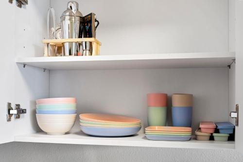 a shelf with bowls and vases on it at Designer Apt w Jacuzzi Walk To Casino & iMax in Sparks