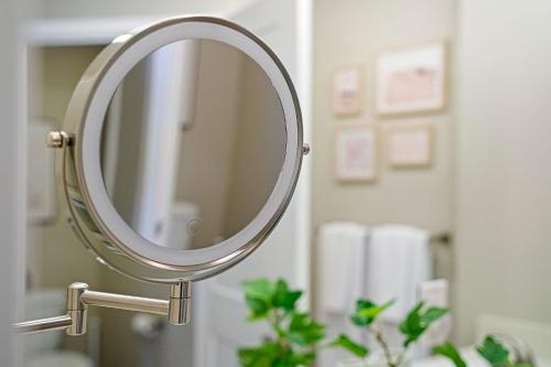 a silver mirror on a sink in a bathroom at Designer Apt w Jacuzzi Walk To Casino & iMax in Sparks