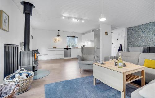 a living room with a couch and a table at Nice Home In Frvang With Wifi, 5 Bedrooms And Outdoor Swimming Pool in Fårvang