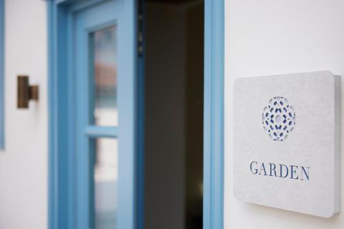 a door with a garden sign on it at Orloff Legacy Suites Hydra in Hydra
