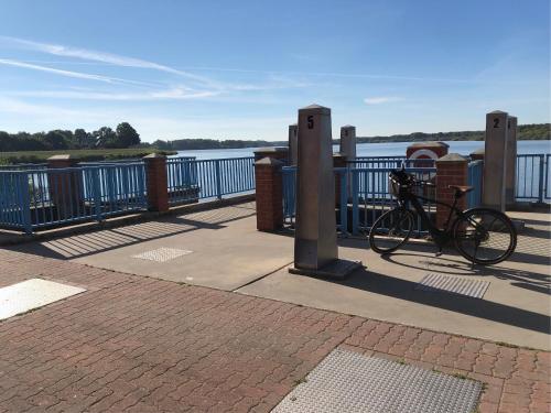 a bike parked on a sidewalk next to the water at Landhaus Saterland Ferienwohnung NEU Emsland Ostfriesland Nordsee in Sedelsberg