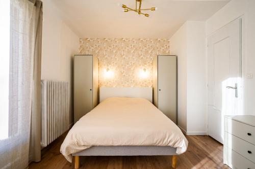 a bedroom with a bed and two closets at The Golden white, Annecy in Annecy