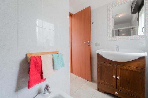 a bathroom with a sink and a mirror at Villino nel Bosco in Capoliveri