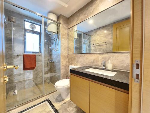 a bathroom with a sink and a shower and a toilet at R&F Princess Cove CIQ Premium Sea View Suites by NEO in Johor Bahru