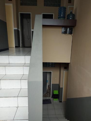 a building with a column in the middle of a room at Penginapan Sriwijaya Semarang in Jomblang