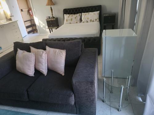 a living room with a couch and a bed at T&V Suites in Windsor