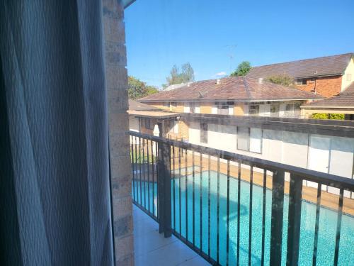 a view of a swimming pool from a balcony at T&V Suites in Windsor