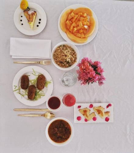 a table with plates of food and bowls of food at DEEPPURA GARH in Sīkar