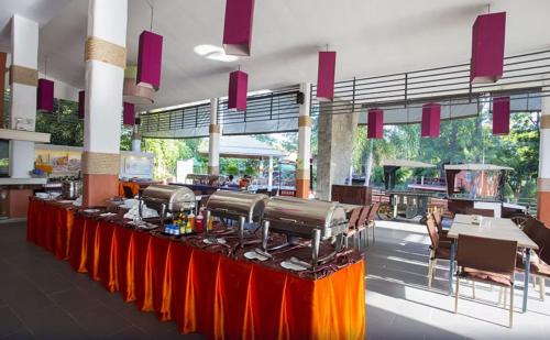 a long table in a building with a red table cloth at Aurora Resort Khao Yai in Mu Si
