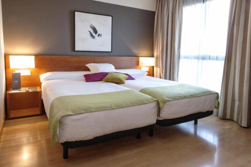 En eller flere senge i et værelse på Zenit Don Yo
