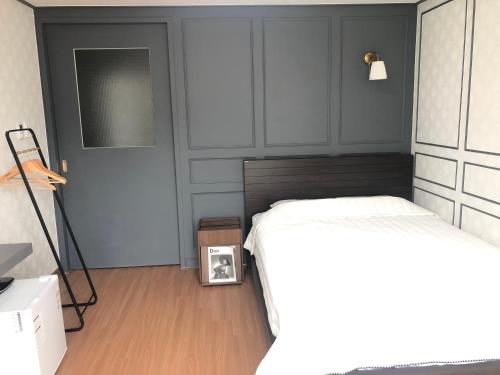 a bedroom with two beds and a clock on the floor at Cheukhu-dong 19street Guesthouse in Mokpo