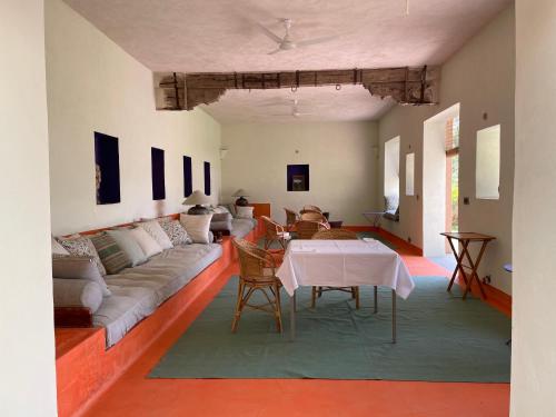 a living room with a couch and a table at DEEPPURA GARH in Sīkar