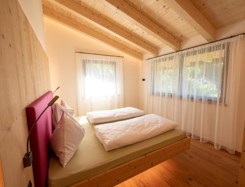 a bedroom with a bed in a room with a window at Sunnegg in Bressanone
