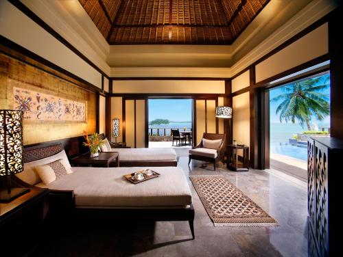a bedroom with a bed and a view of the ocean at Banyan Tree Bintan in Lagoi