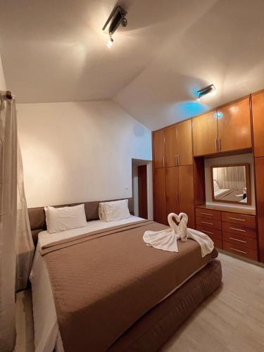 a bedroom with a bed with a towel on it at Oasi Rejuve Villa in Meneou