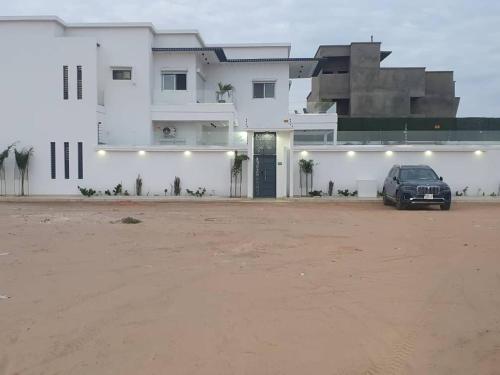 a car parked in front of a white building at Diamond House in Saly Portudal