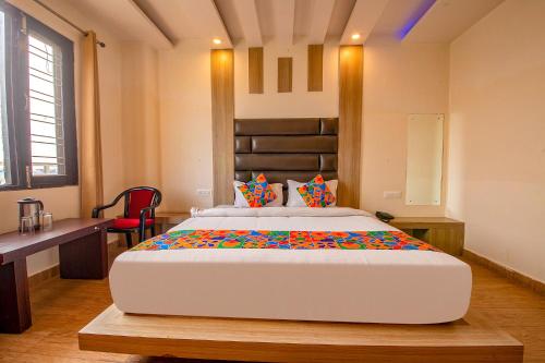a bedroom with a large bed in a room at FabHotel AS Residency in Dehradun