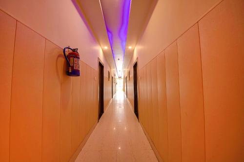 a long hallway with a purple light on the ceiling at FabHotel As Residency in Dehradun