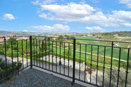 a balcony with a view of a green field at Hotel Ristorante Borgovecchio in Montegrosso dʼAsti