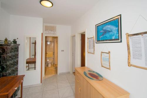 a room with a desk and a picture of a dolphin on the wall at Apartman V in Premantura near the center of town in Premantura