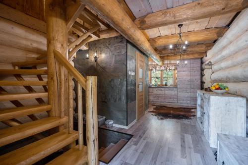 a bathroom with wooden walls and wooden flooring in a log cabin at Chalet Durik Bystra-Jacuzzi-Sauna-Kids playground-Fire pit-Hiking in Horná Lehota