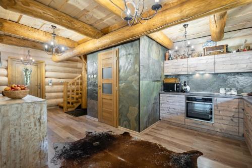 a kitchen with wooden walls and wooden ceilings at Chalet Durik Bystra - Jacuzzi - Sauna - In the forest - 10 min walk to restaurant - On hiking trail in Horná Lehota