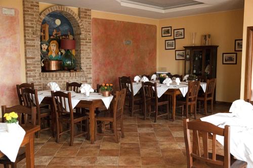 a dining room with tables and chairs in a restaurant at Hotel Ristorante Borgovecchio in Montegrosso dʼAsti