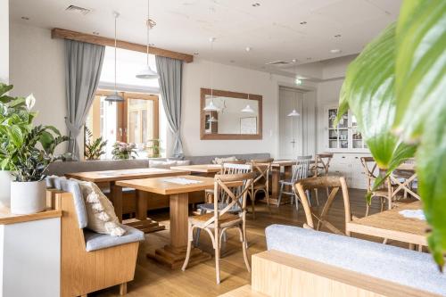 a dining room with wooden tables and chairs at W Dolinie Tylicza in Krynica Zdrój