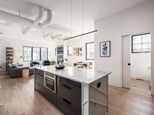 an open kitchen and living room with a large counter top at Historic German Village Industrial Masterpiece in Columbus
