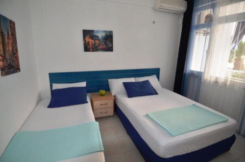 a bedroom with two beds and a window at Studio in Avşa Adası