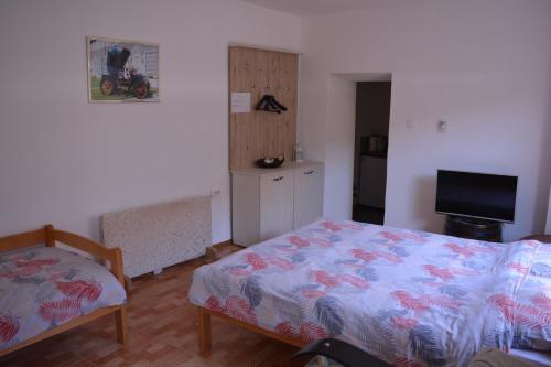 a small bedroom with a bed and a television at PINGO 1 in Despotovac