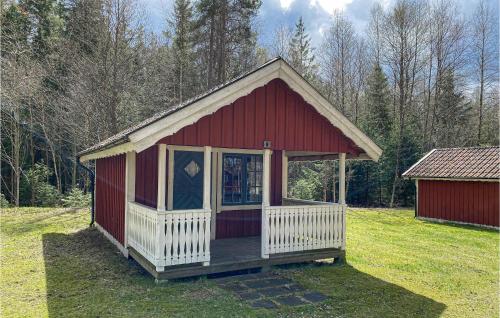 a small red and white shed with a porch at Cozy Home In Jälluntofta With Wifi in Jälluntofta