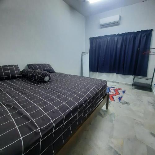 a bedroom with a bed and a blue curtain at Homestay Sunnah Seri Manjung Islam in Seri Manjung