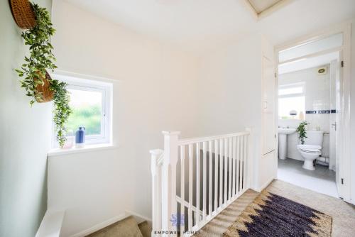 a white staircase in a bathroom with a toilet at Coventry Beautiful House, University Hospital, M6 M69, Private Parking, Sleeps 6, by EMPOWER HOMES in Coventry