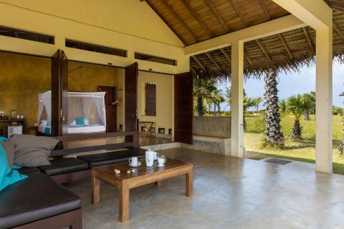 a living room with a couch and a coffee table at Elements Beach & Nature Resort in Kalpitiya