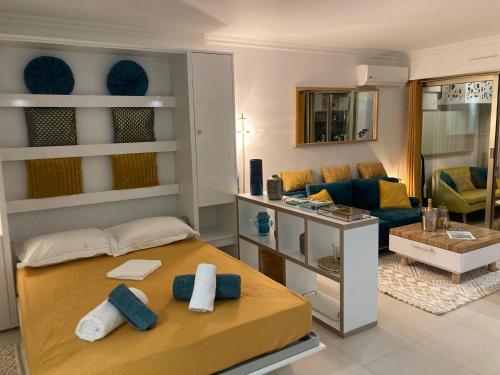 a bedroom with a bed and a living room at Appartement de standing Le Velvet Bay climatisé en bord de mer in Antibes