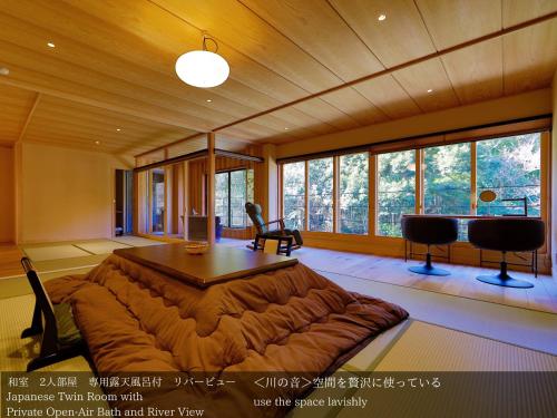 a living room with a large couch and a table at Tatsuta Ryokan in Izu