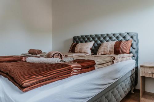 a large bed with blankets and pillows on it at David 3 in Ruma
