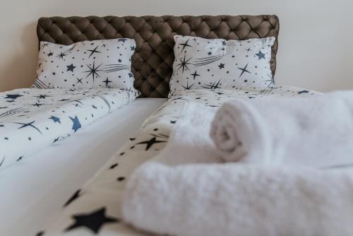 a bed with black and white pillows at David 3 in Ruma