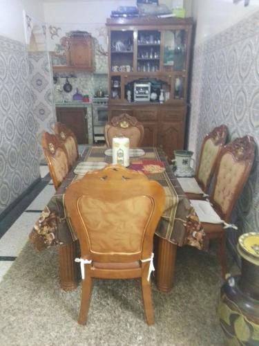 a dining room with a table and chairs at Immeuble chakir in Meknès