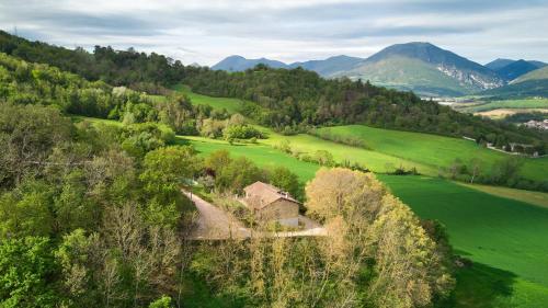 an aerial view of a house in a green field at Villa Belveder - Piscina, Parco e Vista by Host Hero in Castelraimondo