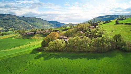 an aerial view of a green field with houses and trees at Villa Belveder - Piscina, Parco e Vista by Host Hero in Castelraimondo