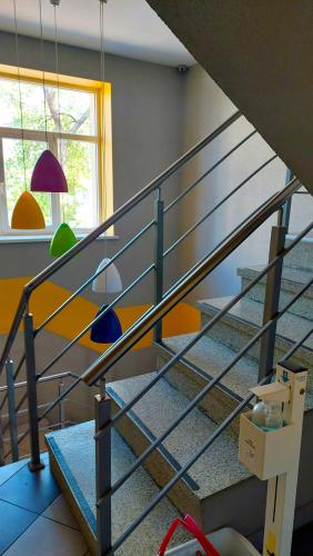 a metal staircase in a room with a window at Happy Hotel in Rīga