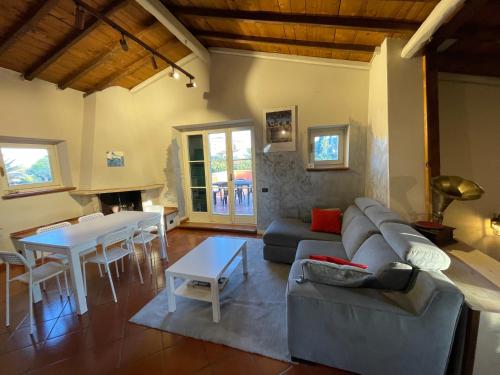 a living room with a couch and a table at Il Casale di B in Acilia