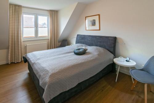 ドルヌマージールにあるFerienhaus Finjaのベッドルーム1室(ベッド1台、テーブル、椅子付)