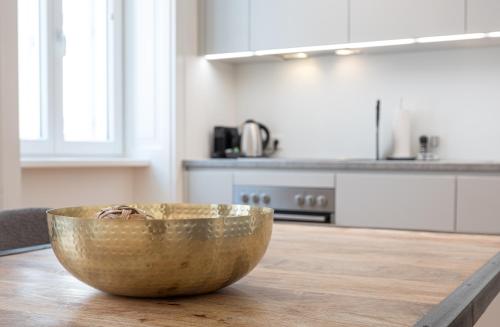 a wooden bowl sitting on a wooden table in a kitchen at Mint@Naschmarkt Premium Apartments in Vienna
