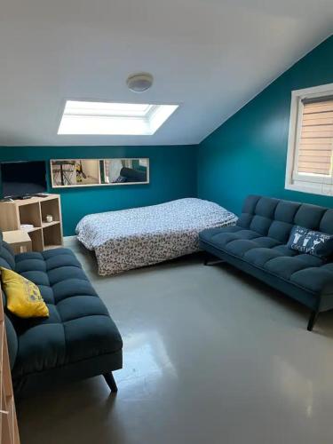 a living room with a couch and a bed at Activités Et Nature Appartement in Vignot